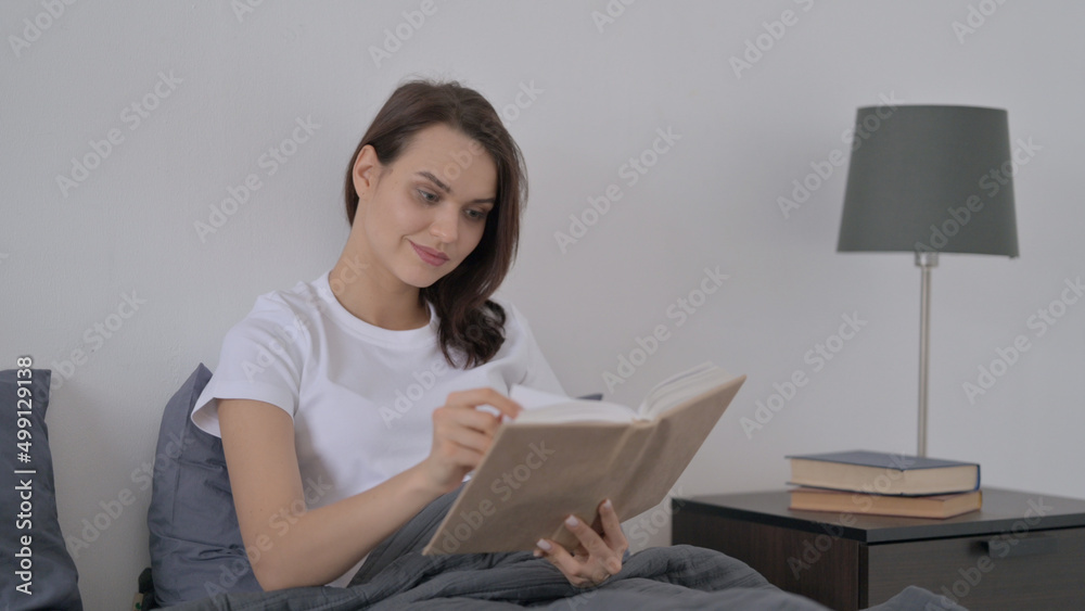 Woman Reading Book while Sitting in Bed Woman Reading Book while Sitting in Bed