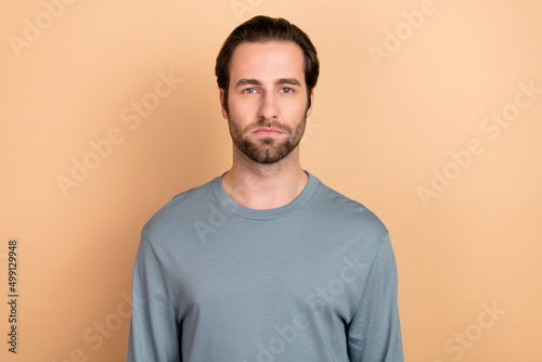 Photo of young man smart professional representative wear casual clothes isolated over beige color background