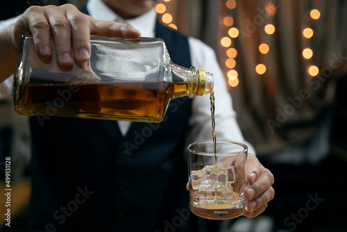 Barman pouring whiskey whiskey glass beautiful night