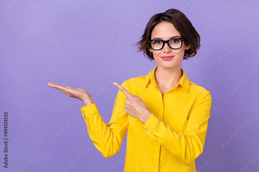 Photo of optimistic millennial ceo lady hold empty space wear formal cloth eyewear isolated on violet color background Photo of optimistic millennial ceo lady hold empty space wear formal cloth eyewear isolated on violet color background