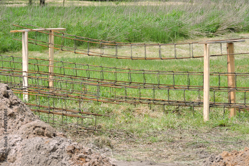 The steel rebar made of reinforcing bars and steel wires, green grass The steel rebar made of reinforcing bars and steel wires, green grass