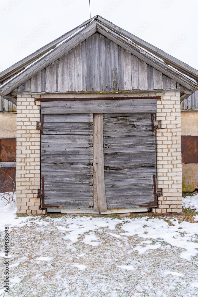 Old Wooden Shed Doors Exterior on White Brick Wall Old Wooden Shed Doors Exterior on White Brick Wall