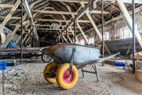 Wheelbarrow with Yellow tires inside old abandoned warehouse