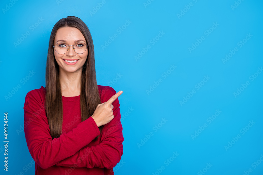 Photo of cute millennial lady index promo wear eyewear red shirt isolated on blue color background Photo of cute millennial lady index promo wear eyewear red shirt isolated on blue color background