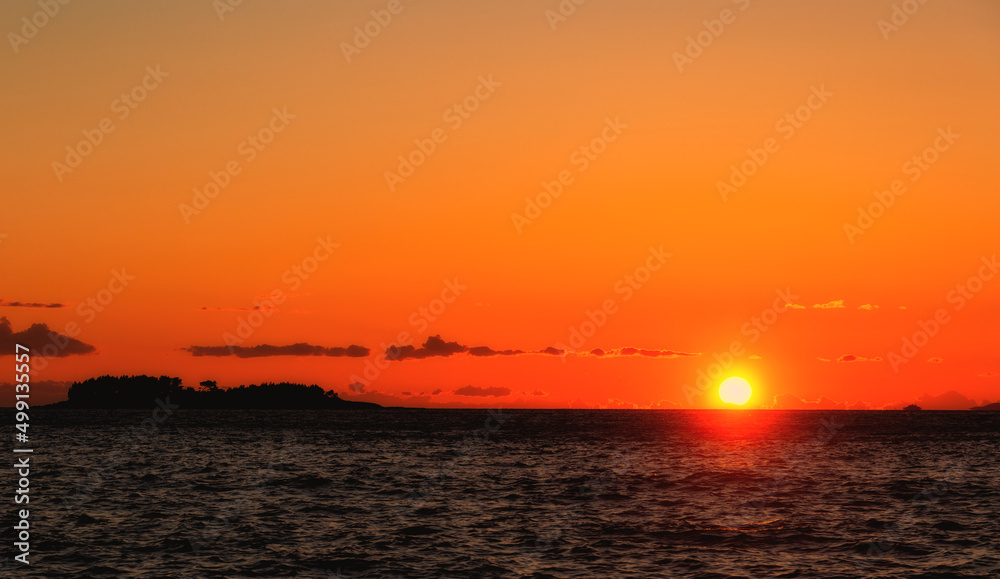 The sun sets over the horizon in the Adriatic Sea The sun sets over the horizon in the Adriatic Sea
