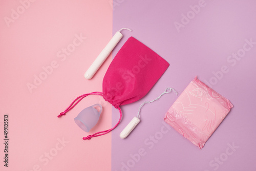 Pad Menstrual Cup Tampon on Pink and Purpl Background The view is flat Concept of critical days menstruation