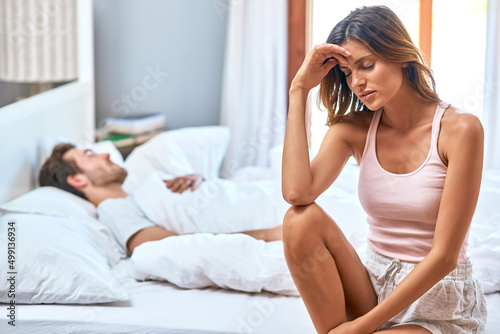 Its heartbreaking to have a troubled relationship. Shot of a young couple having marital problems in the bedroom at home.