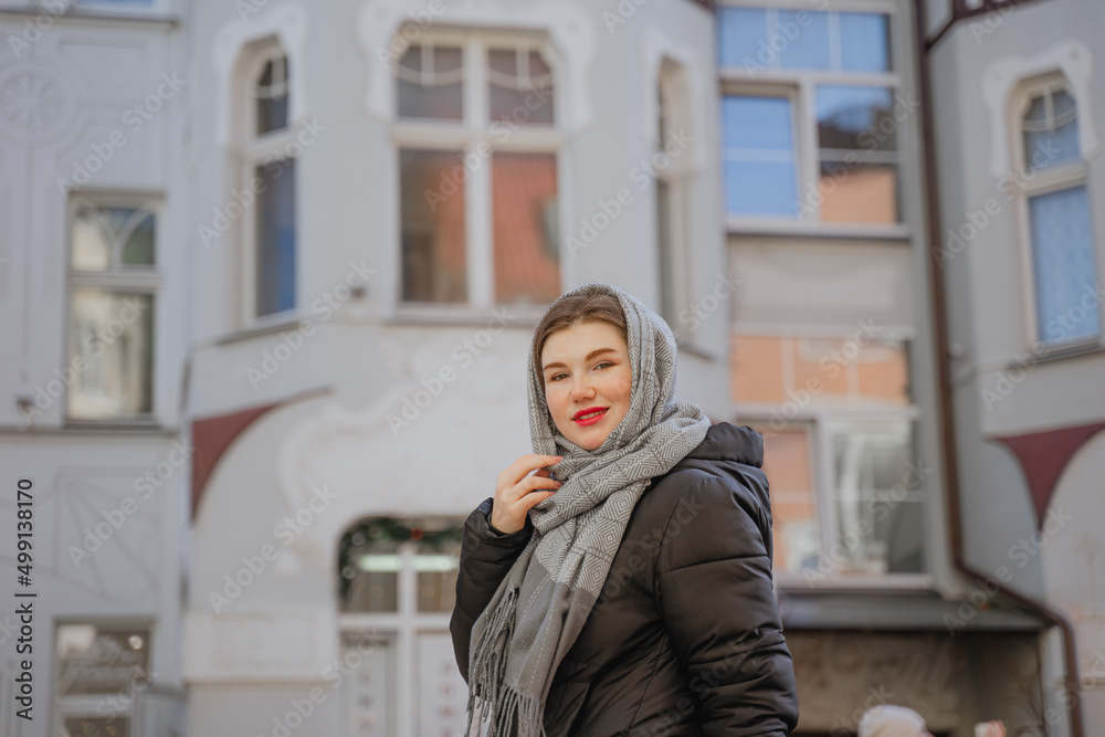 Fototapeta premium girl in a headscarf and red lips on a walk