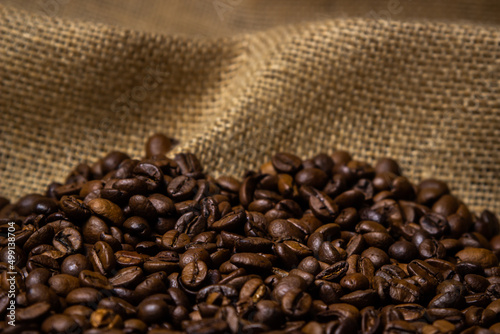 Roasted coffee beans on burlap. Production and roasting of coffee beans