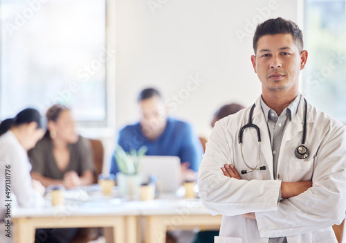 Saving lives is my number one priority. Shot of a young male doctor standing with his arms crossed in an office at work.