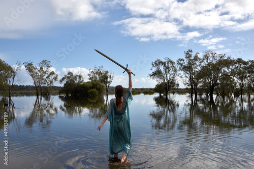Tableau sur toile Portrait of beautiful girl wearing flowing  fantasy gown in a magical lake background