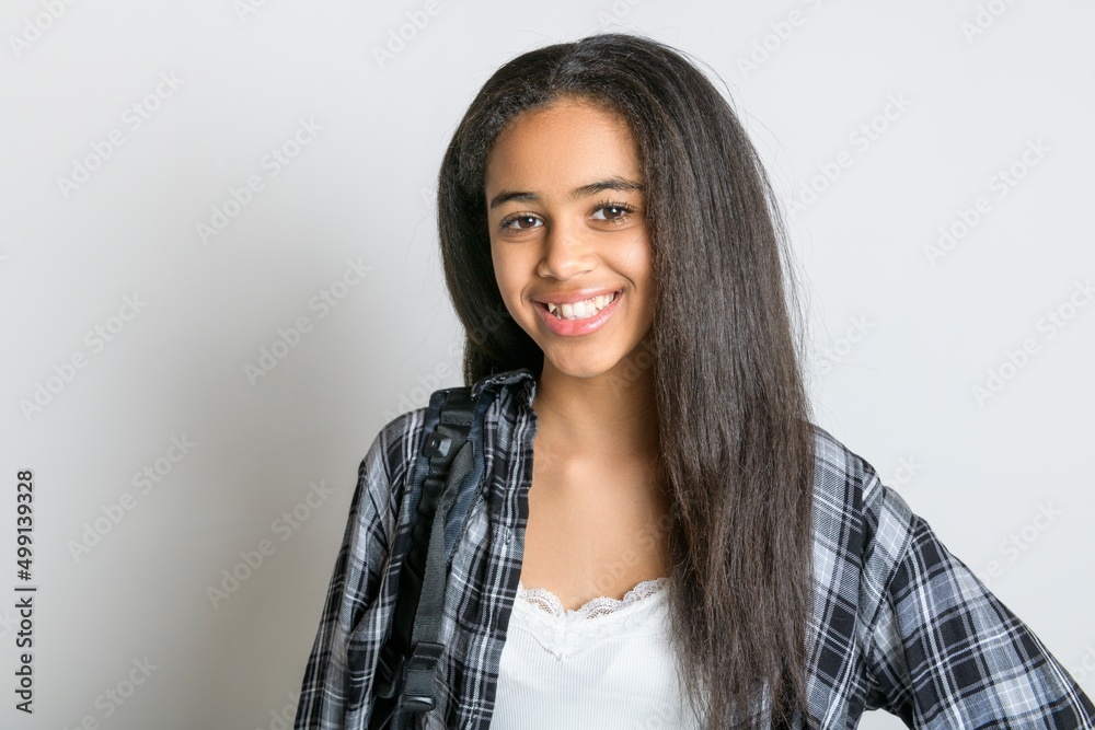 Beautiful black school girl posing on studio white background Beautiful black school girl posing on studio white background
