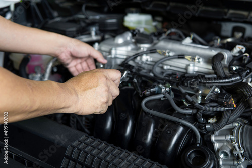 Man use Open-ended wrench for basic car repairs by yourself in engine room , car service concept