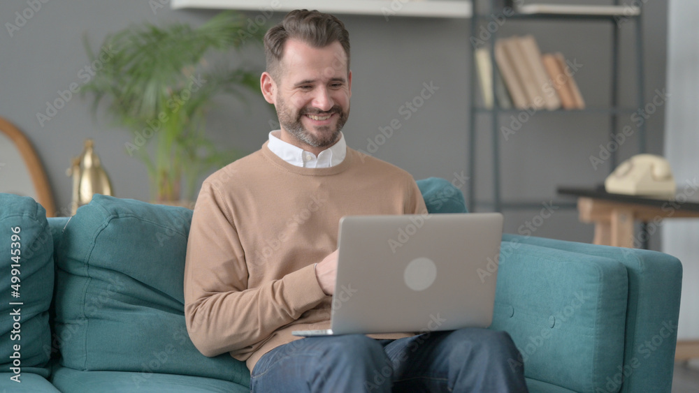 Man doing Video Call on Laptop on Sofa Man doing Video Call on Laptop on Sofa
