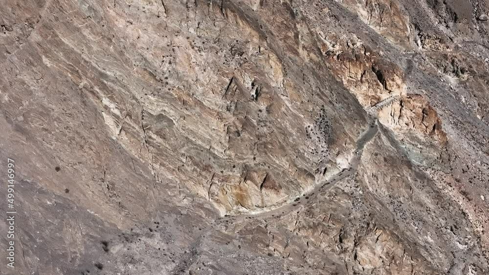 Pakistani trucks travel on dangerous paved road along the mountain, transport goods via Karakoram highway. Gilgit Baltistan, Pakistan. Pakistani trucks travel on dangerous paved road along the mountain, transport goods via Karakoram highway. Gilgit Baltistan, Pakistan.