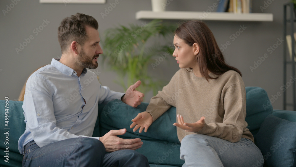 Woman Talking to Man While Sitting on Sofa Woman Talking to Man While Sitting on Sofa