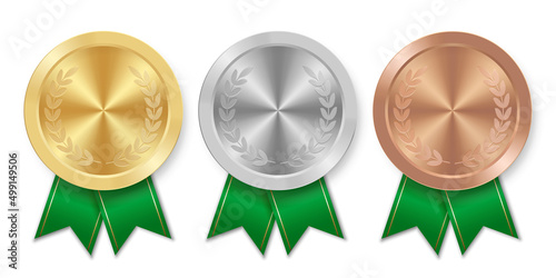 Golden silver and bronze award sport medal with green ribbons
