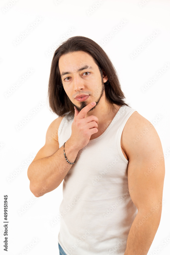 Young muscular man touching his beard and looking at the camera medium shot white background studio shot . High quality photo Young muscular man touching his beard and looking at the camera medium shot white background studio shot . High quality photo