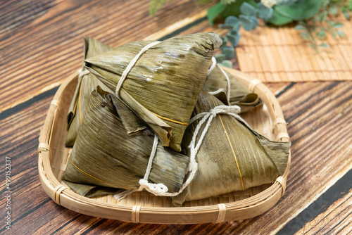rice dumpling is a traditional Chinese rice dish made of glutinous rice and wrapped in bamboo leaves, Dragon Boat Festival is making and eating zongzi with family