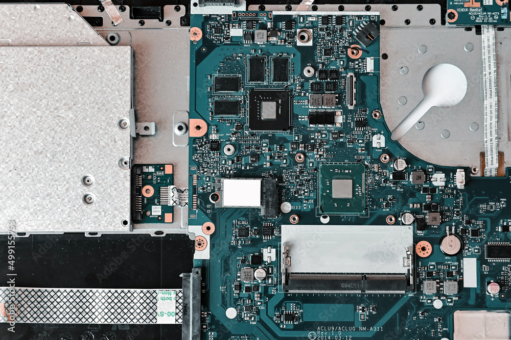 Fototapeta premium laptop repair. disassembled laptop, troubleshooting, fault diagnosis, problem search, motherboard (main board) close-up. top view