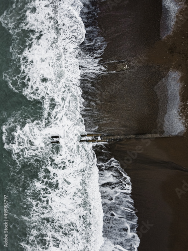 Aerial drone photo of sea beach with wave splash cloudy weather after before the storm island beach (ID: 499155797)