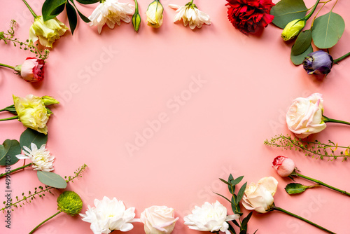 Fototapeta Naklejka Na Ścianę i Meble -  flowers, buds of flowers, roses and chrysanthemums, carnations on a pink background, buds and leaves lie beautifully with a place for text and congratulations