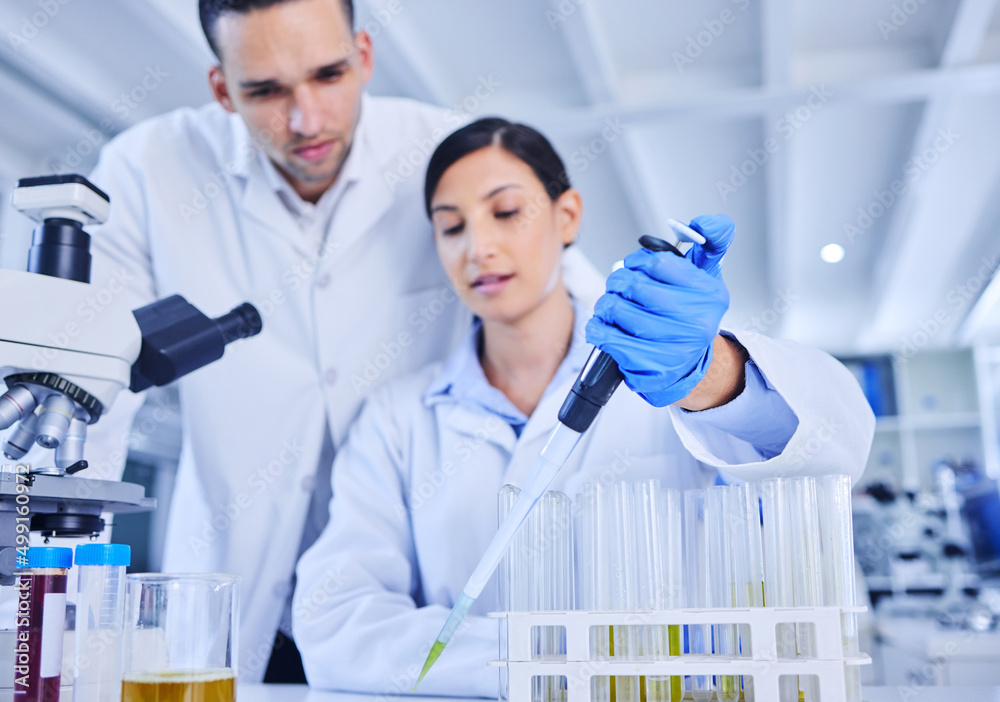 Is this correct. Cropped shot of two young scientists working together in their lab. Is this correct. Cropped shot of two young scientists working together in their lab.