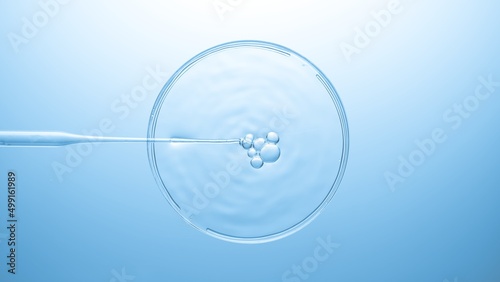 Top view macro shot of air bubbles comes out from lab dropper and floats on the surface of clear liquid in petri dish on pale blue background | Abstract beauty product formulation