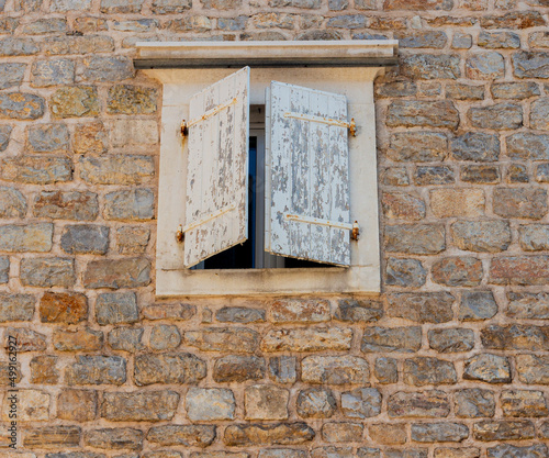 old window on stone wall