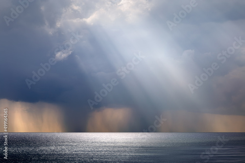 Rainy weather over the sea. Shower and rays of the sun on the horizon of the sea created a fantastic panorama.