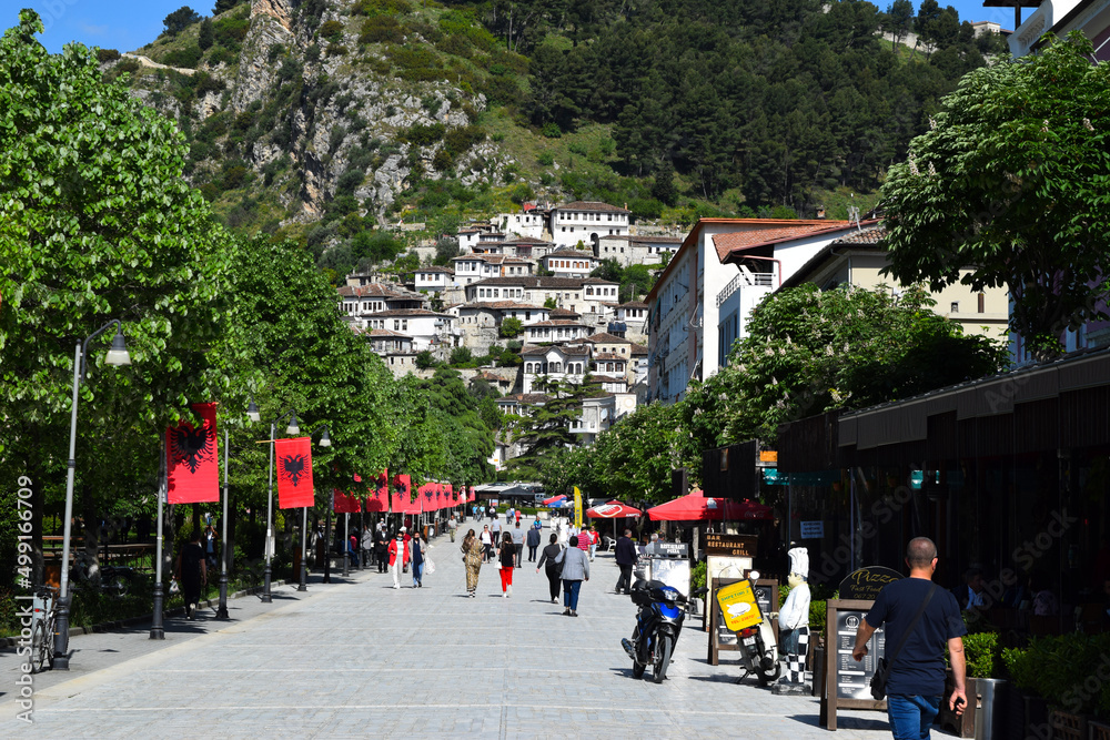 The main pedestrian street of Berat, with a view of the old town in the background, is called the city of a thousand windows or the city of a thousand lights