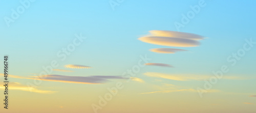 Lenticular clouds in the sky at dusk.