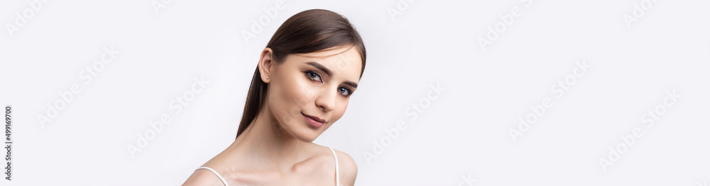 Beautiful smiling woman with clean skin, natural make-up and white teeth on a gray background Beautiful smiling woman with clean skin, natural make-up and white teeth on a gray background