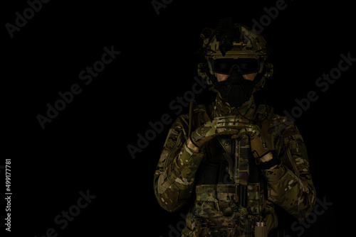 SOF special forces soldier wearing US made gear, crye precision, ops core. Studio portrait  isolated on black background 
