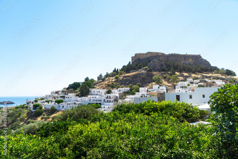 View of Lindos, archaeological site, a fishing village and a former municipality on the island of Rhodes, in the Dodecanese, Greece. View to the Acropolis of Lindos