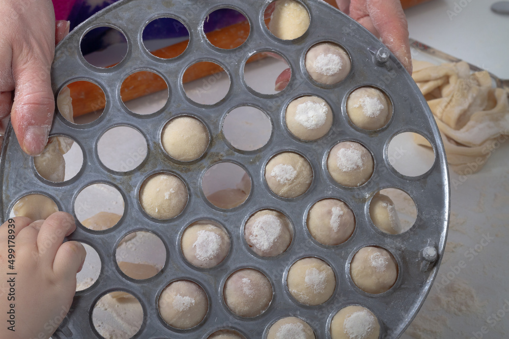 Take out handmade dumplings from a metal dumpling bowl Take out handmade dumplings from a metal dumpling bowl