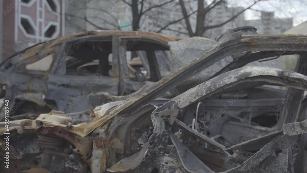 Burnt cars in a parking lot near residential buildings after the city was bombed. Ukraine. Kyiv. District Troieshchyna Burnt cars in a parking lot near residential buildings after the city was bombed. Ukraine. Kyiv. District Troieshchyna