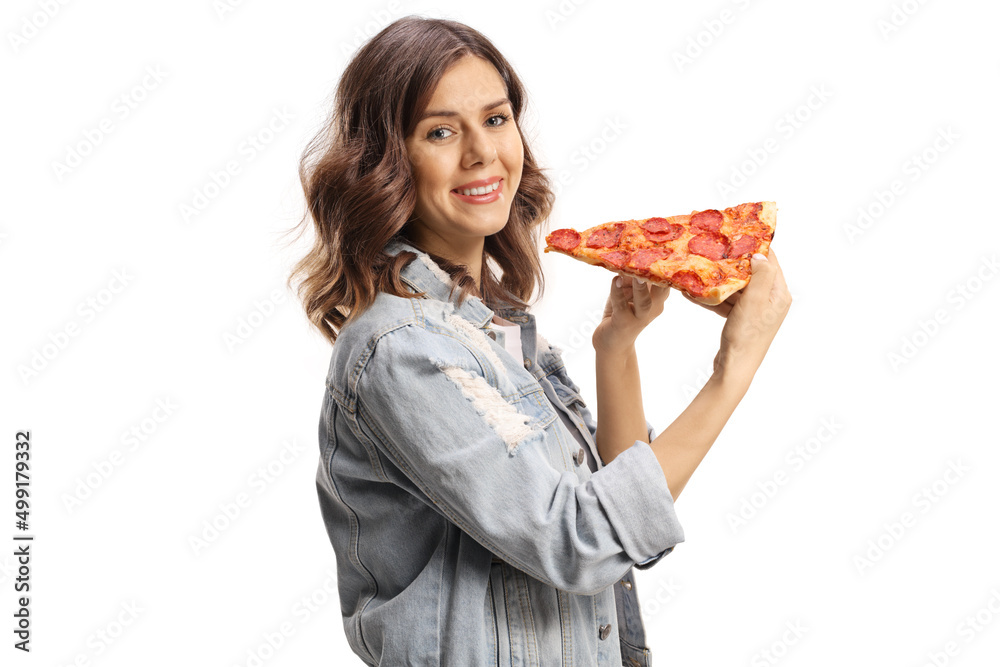 Young female holding a slice of pepperoni pizza and smiling Young female holding a slice of pepperoni pizza and smiling