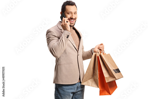 Man using a smartphone and holding shopping bags