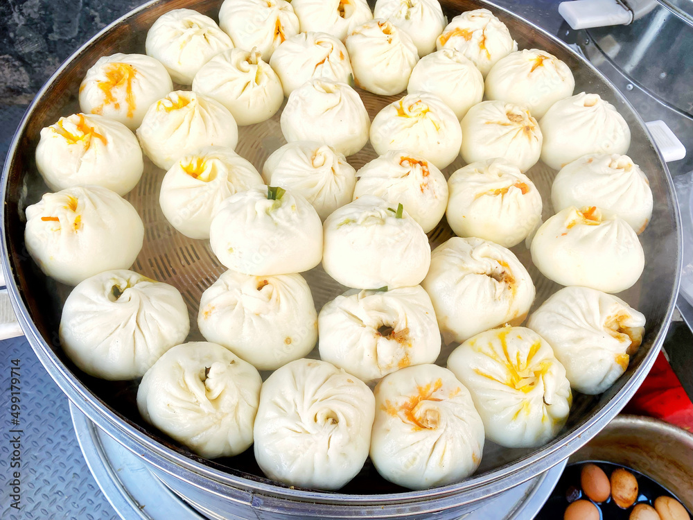 Steamed steamed buns in a cage, traditional Chinese breakfast food in Asian countries, rich in nutrition, with meat and greens fillings and various ingredients, various flavors Steamed steamed buns in a cage, traditional Chinese breakfast food in Asian countries, rich in nutrition, with meat and greens fillings and various ingredients, various flavors