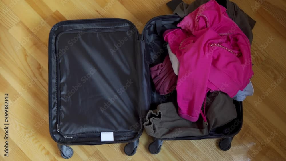 Multi-colored things flying into a suitcase. Collect things for a tourist trip. Multi-colored things flying into a suitcase. Collect things for a tourist trip.