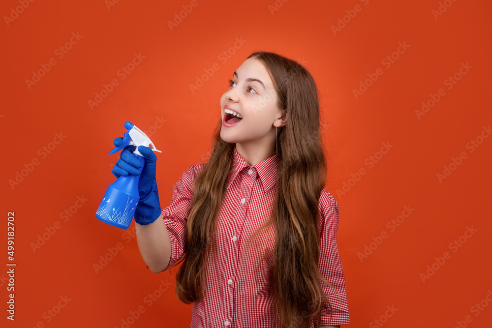 glad child in rubber gloves with spray bottle on red background glad child in rubber gloves with spray bottle on red background