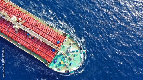 Aerial drone top down photo of huge latest technology crude oil tanker cruising in Mediterranean deep blue sea, Greece