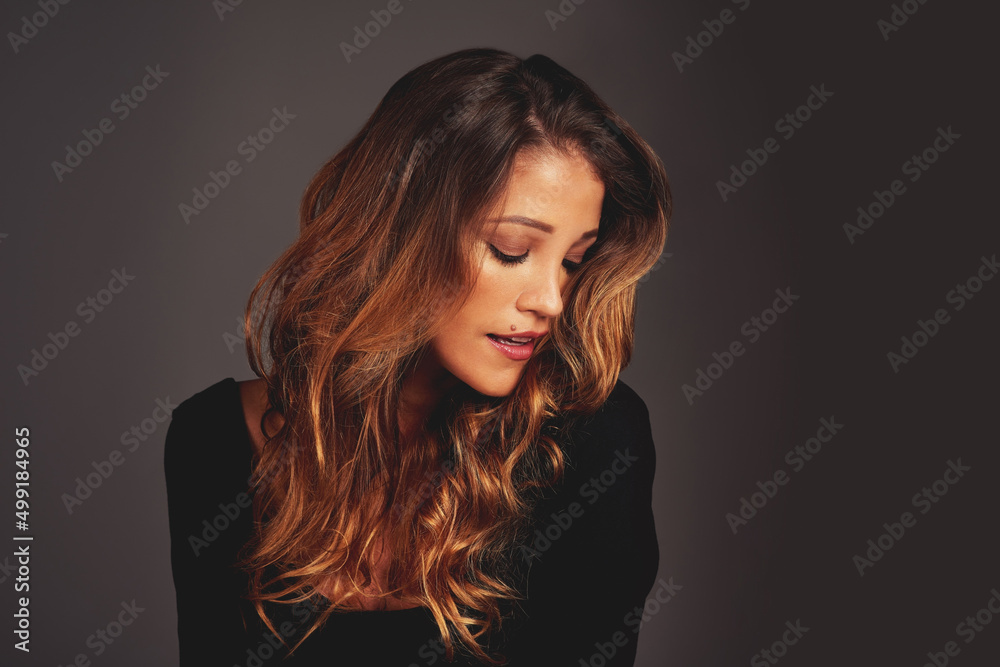 Fototapeta premium Gorgeous hair is the best revenge. Studio shot of a beautiful woman with long locks posing against a grey background.