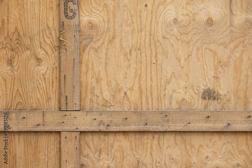 closeup of the side of a large wooden box for transporting valuables with the slats forming a cross