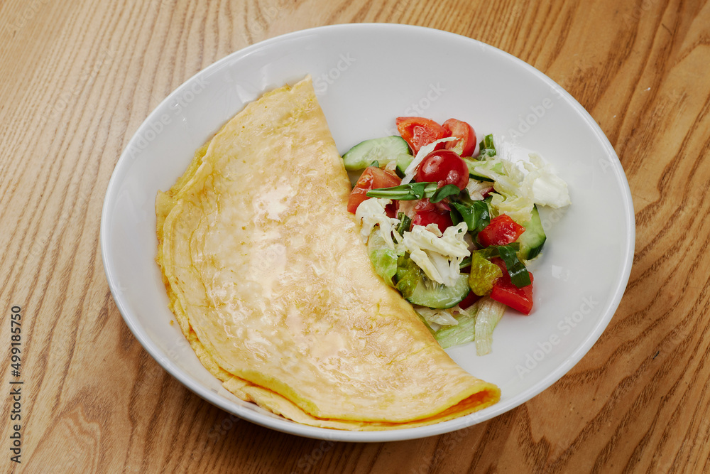 big omelet with vegetable salad big omelet with vegetable salad