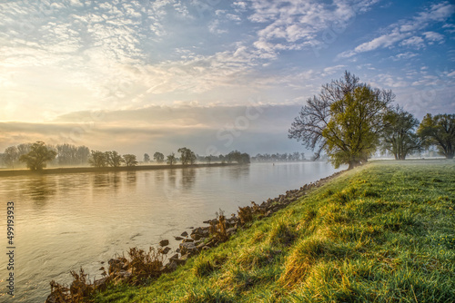 The river danube between the rural towns Osterhofen and Winzer in lower bavaria during sunrise in early spring photo