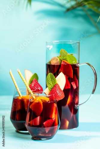Two glasses and a jar with spanish summer cocktail Sangria 