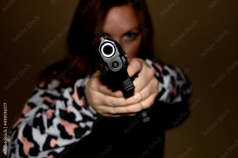 woman with gun pointed at camera looking down barrel woman with gun pointed at camera looking down barrel
