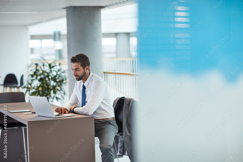 © Daniel L/peopleimages.com - Time to focus and get down to business. Shot of a young businessman working on a laptop in an office.